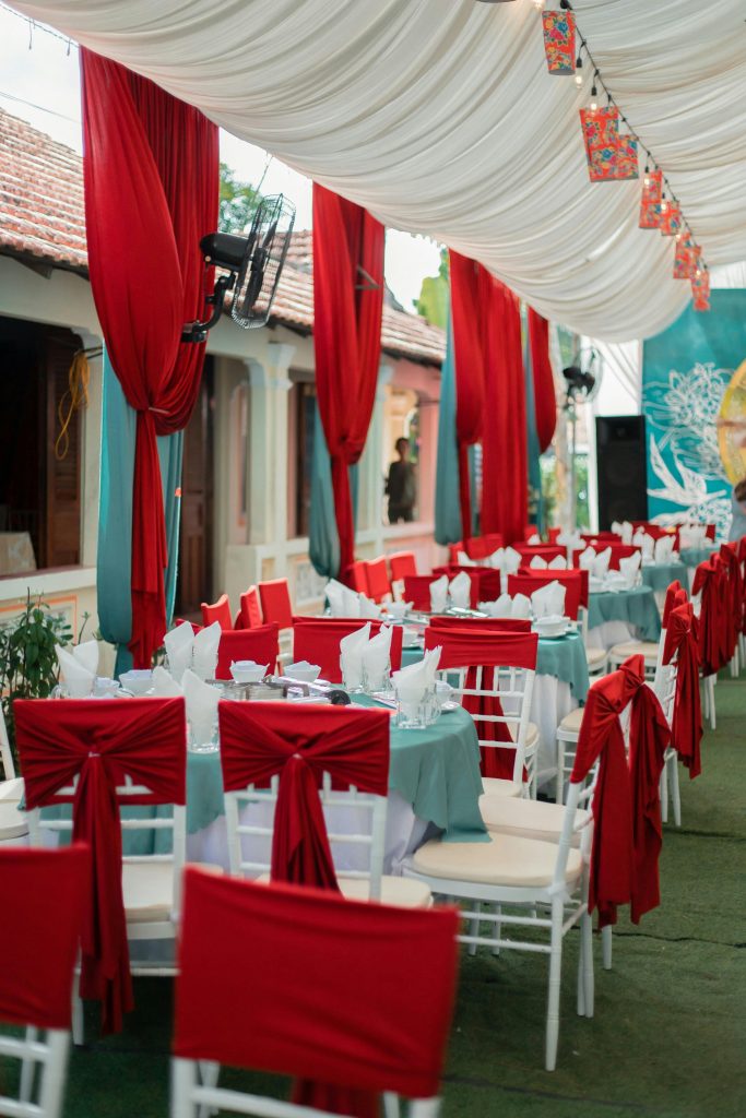 Luxurious outdoor banquet setup with red and white decor, perfect for events.